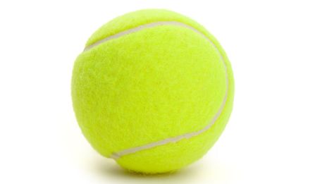 The image shows a bright yellow tennis ball with its distinctive white curved seam pattern against a white background.